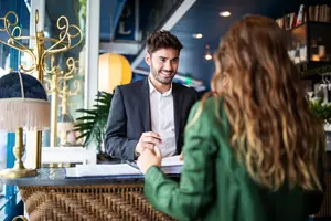 Hotel receptionist assisting guest for checking in