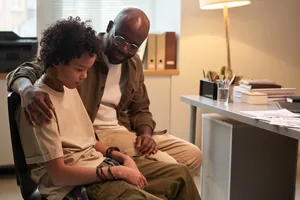 Boy visiting psychologist with father